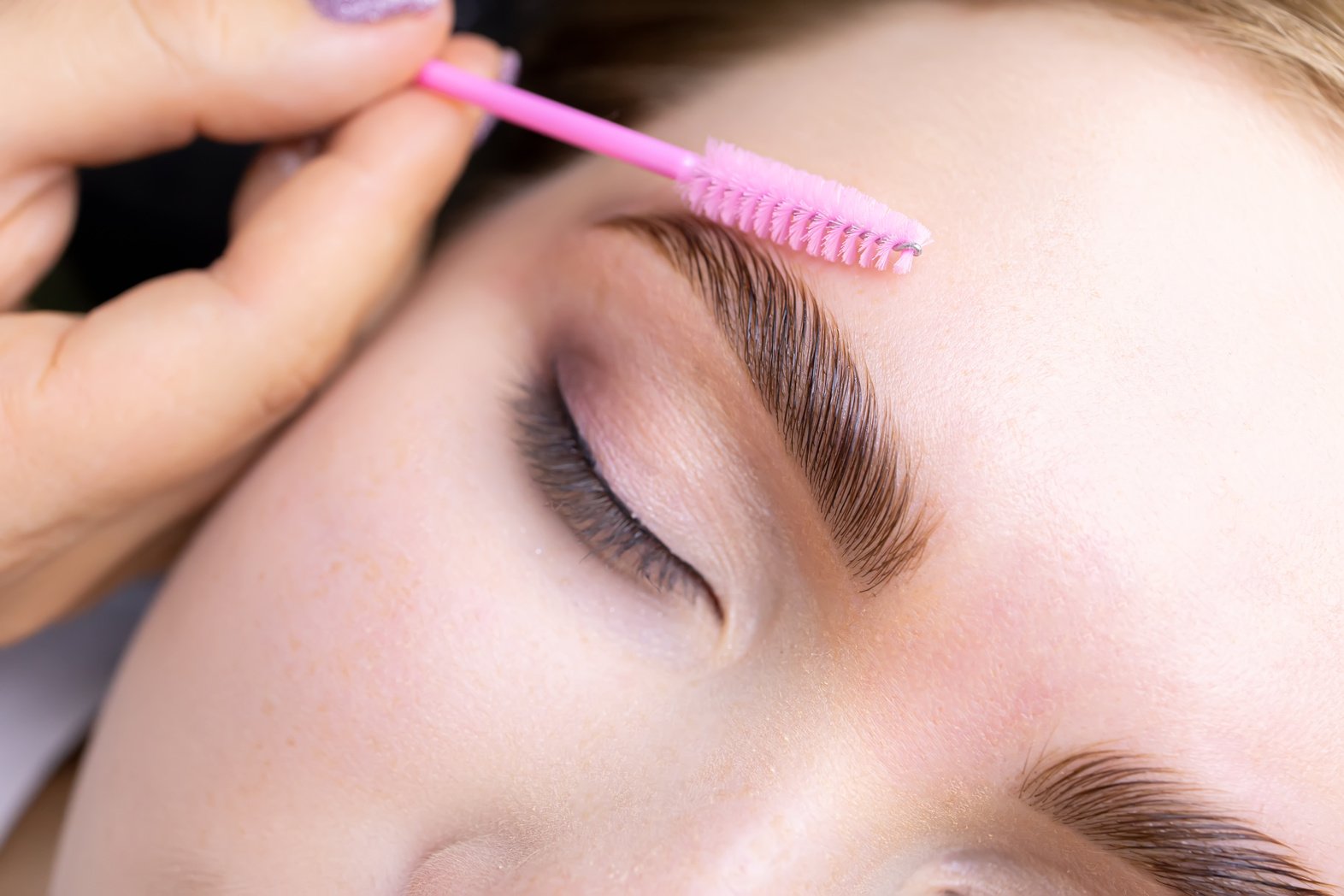 Macro Photography of the Model's Hairs the Master Combs the Eyeb